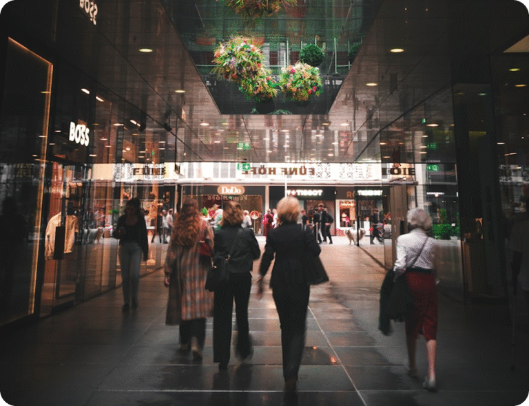 Människor i rörelse genom modern butiksgalleria i Norden, symbol för framtidens handel.